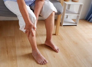 Woman holding her leg in pain due to DVT symptoms in Portland, OR
