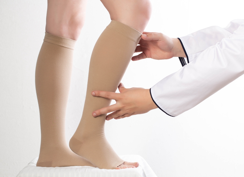 Close up of legs wearing compression socks to reduce leg swelling in Portland, OR