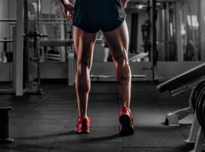 Man's muscular legs during a gym work out, avoiding varicose veins in Portland, OR